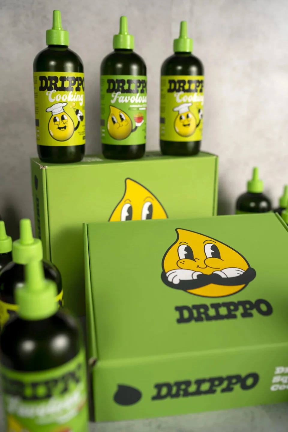 Bottiglie e confezioni Drippo con le diverse versioni della mascotte